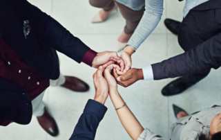 Five people holding hands team work